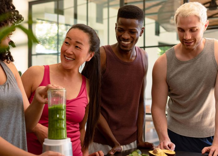 diverse group of friends preparing a smoothie